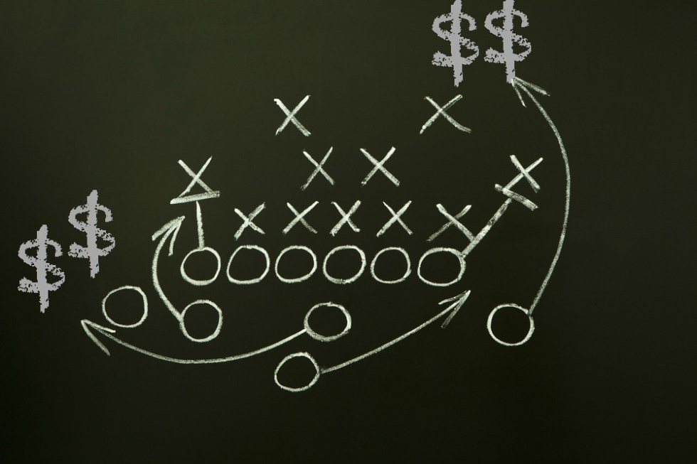 Image of a football play with dollar signs shown along receiver routes. The image is meant to depict the opportunities for marketers to capitalize on the excitement and increased number of games that are a part of the new College Football Playoff system