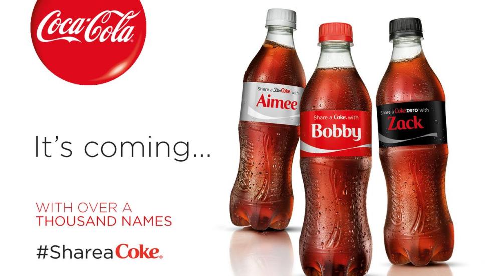 An advertisement for “Share a Coke” shows three Coke bottles with different first names on them.