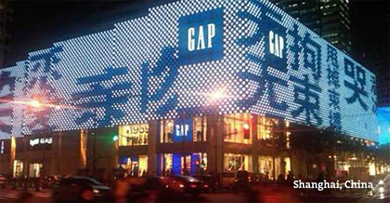 A city corner in Shanghai, China with a digital GAP billboard.